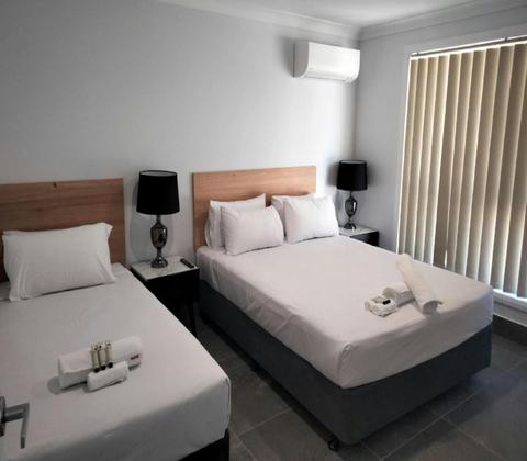 Photo of two beds inside stockman motels two bedroom family unit