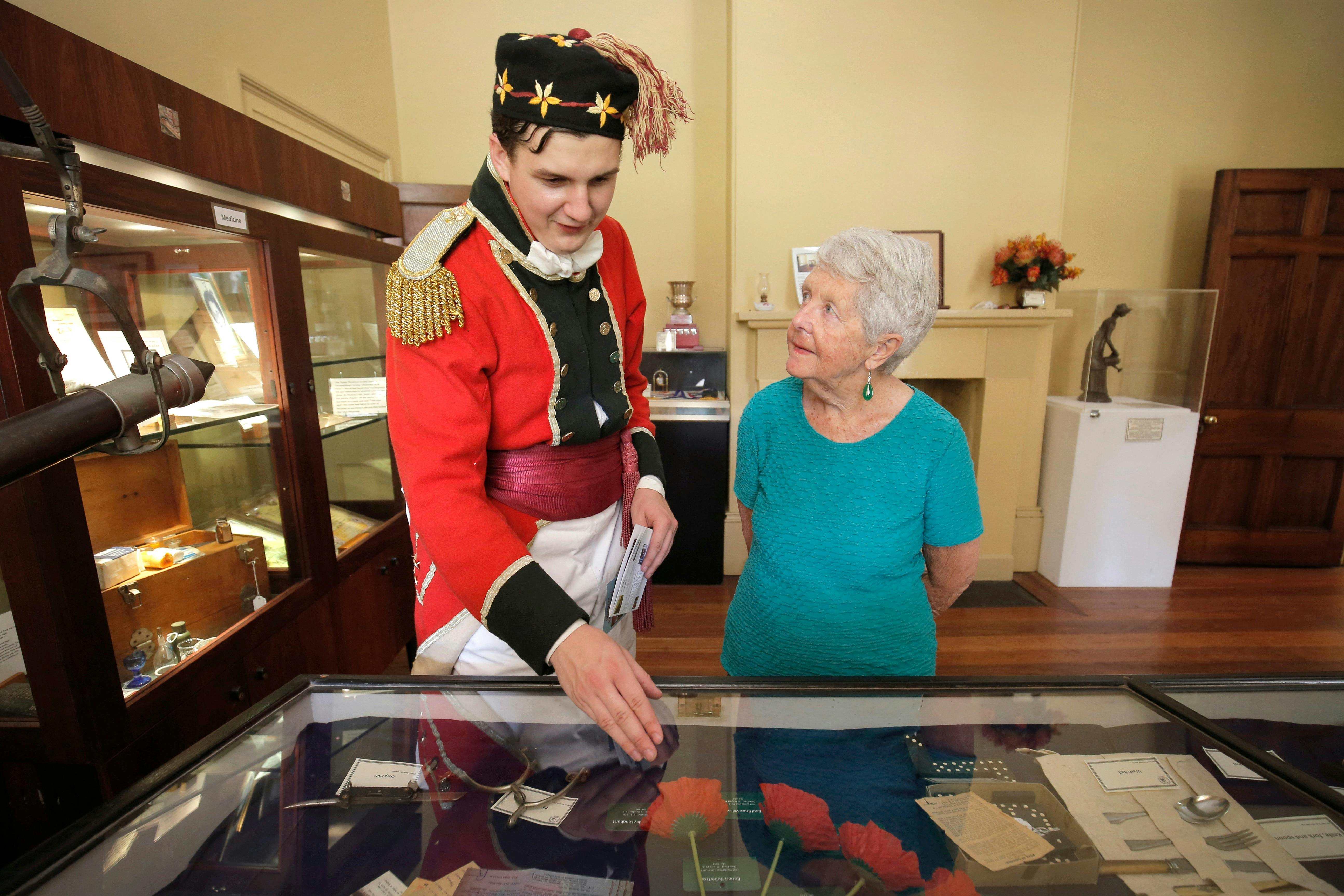 Patrons looking at museum items on guided tour