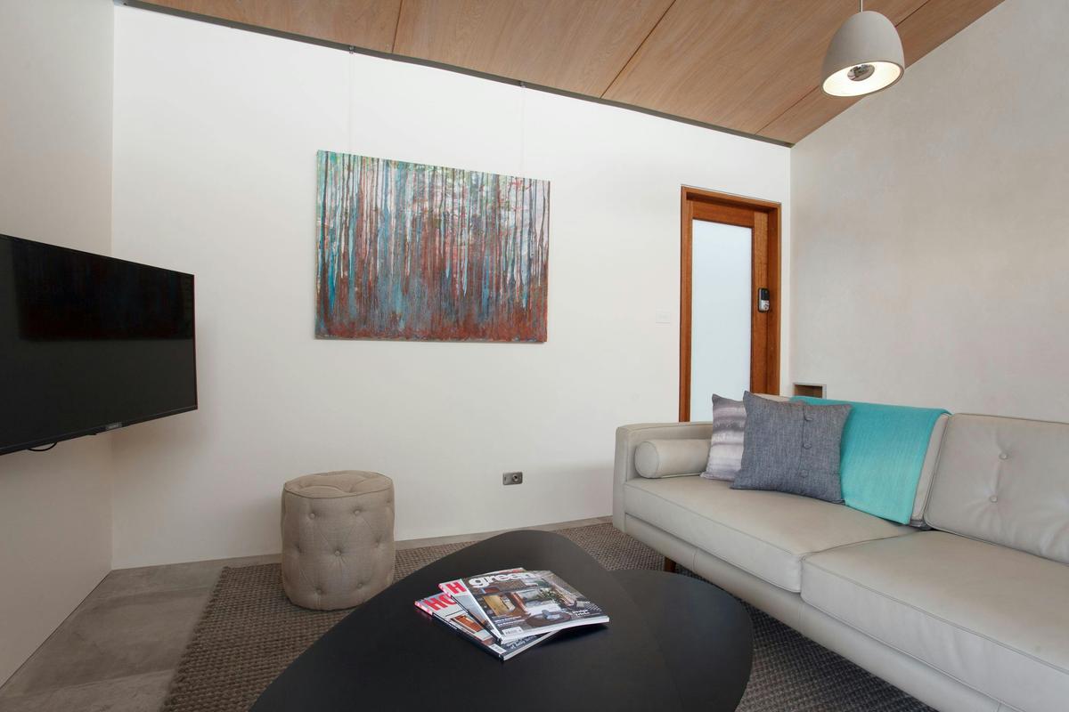 Leather couch and 40 inch television ensures a comfortable visit