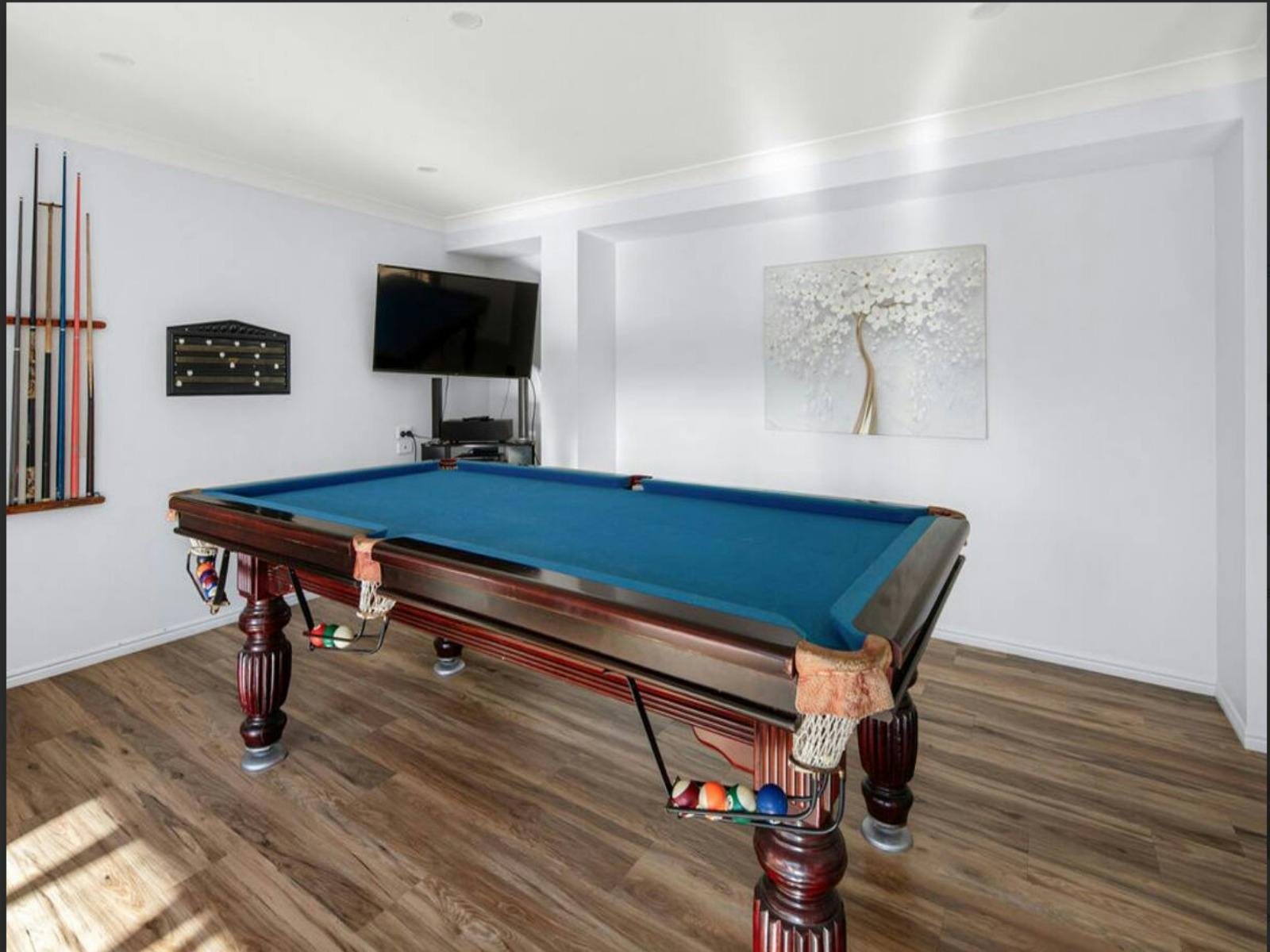 Game on! This stylish game room features a classic pool table, ready for some friendly competition.