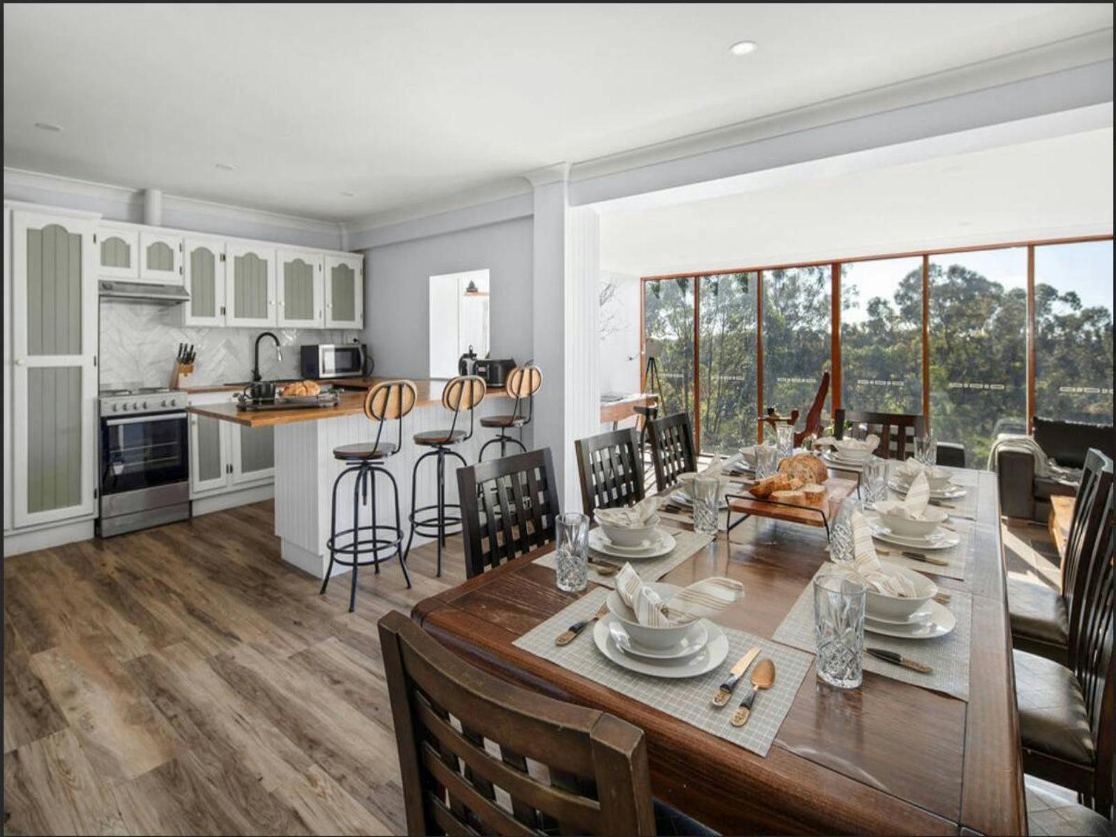 spacious open-plan kitchen and dining area, perfect for entertaining guests, with a stunning view