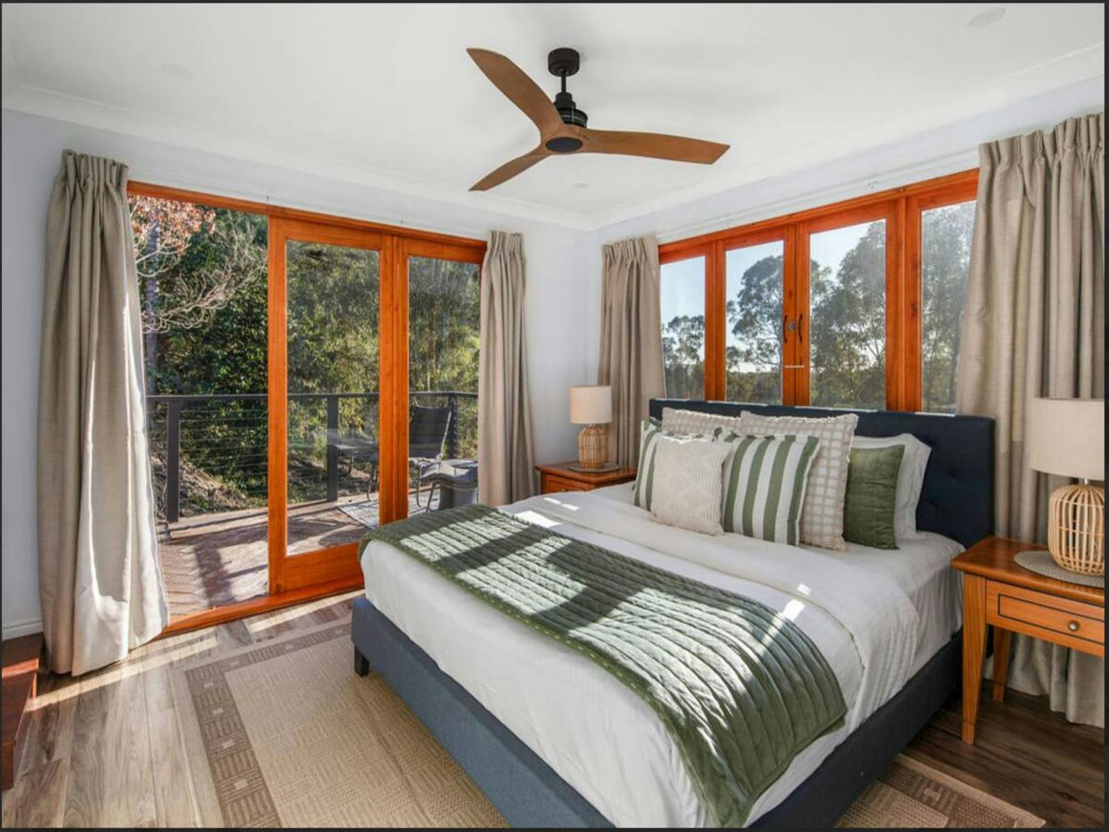 Wake up to breathtaking views from this serene bedroom, featuring a king-size bed