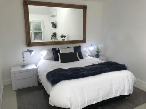 comfortable queen bed and large mirror