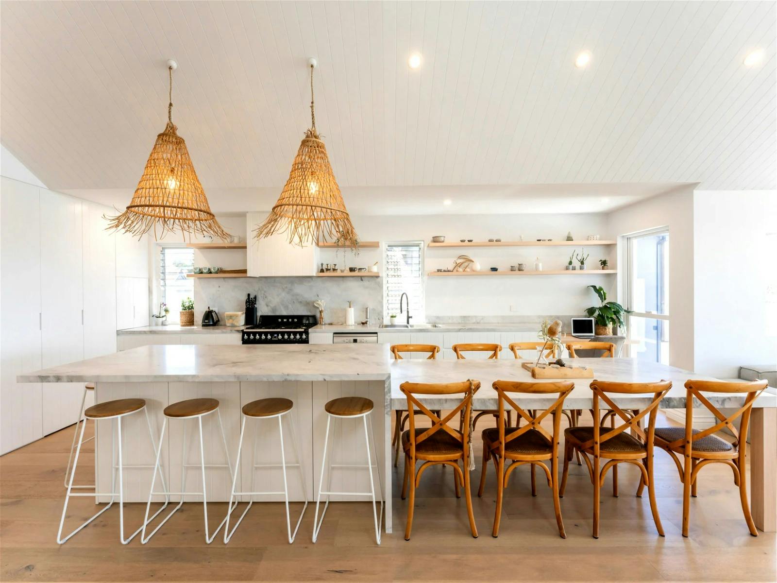 kitchen with its stunning marble bench that flows from bar seating into proper dining