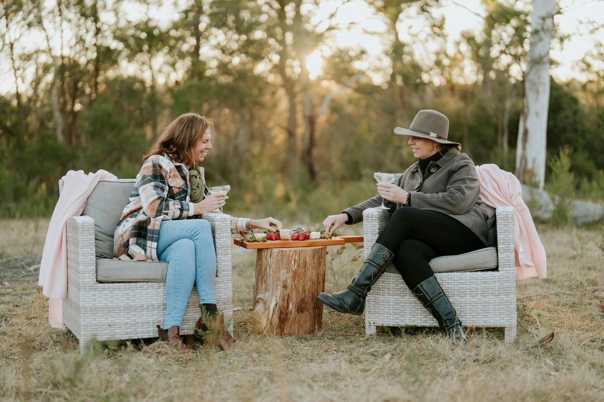 2 friends enjoying a cocktail and platter experience on the farm- hopefully they get to spot some ka