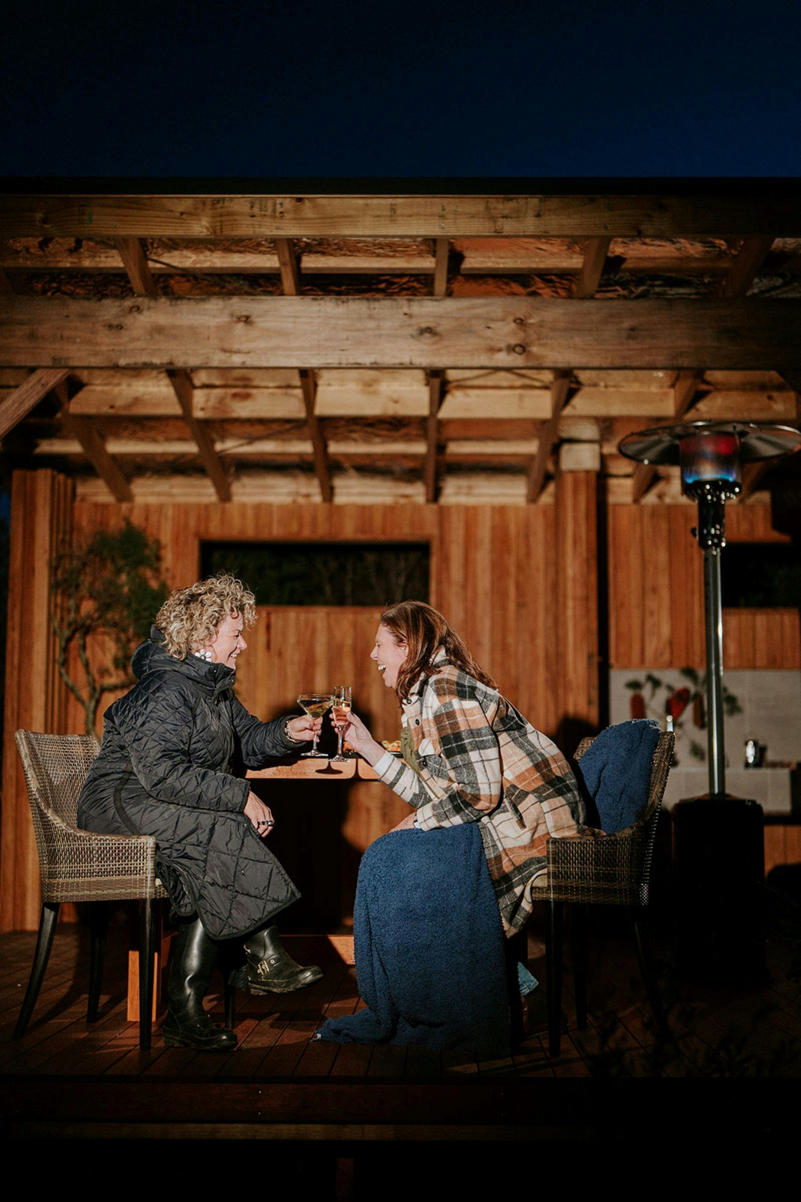 Laughing and connecting on your heated outdoor dining deck
