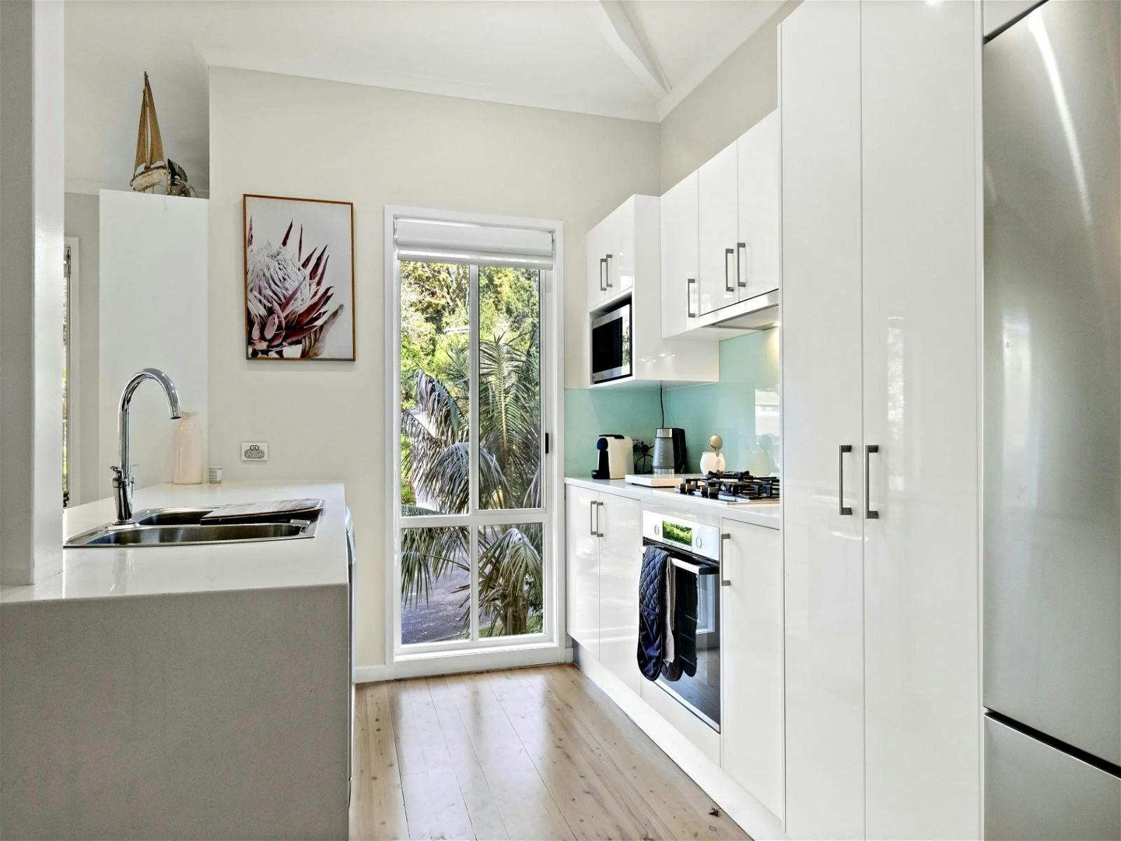 Seperate kitchen area with modern appliances and ample storage