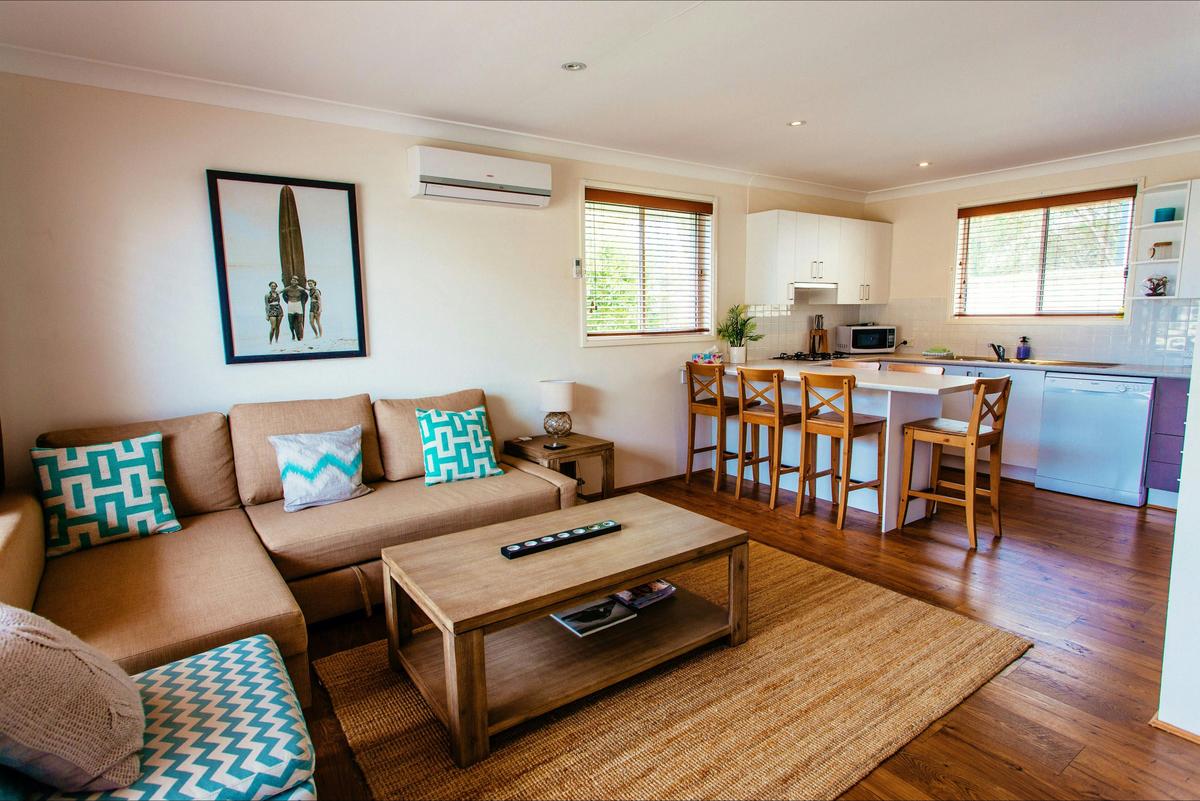 Cosy living area with open plan kitchen and dining.