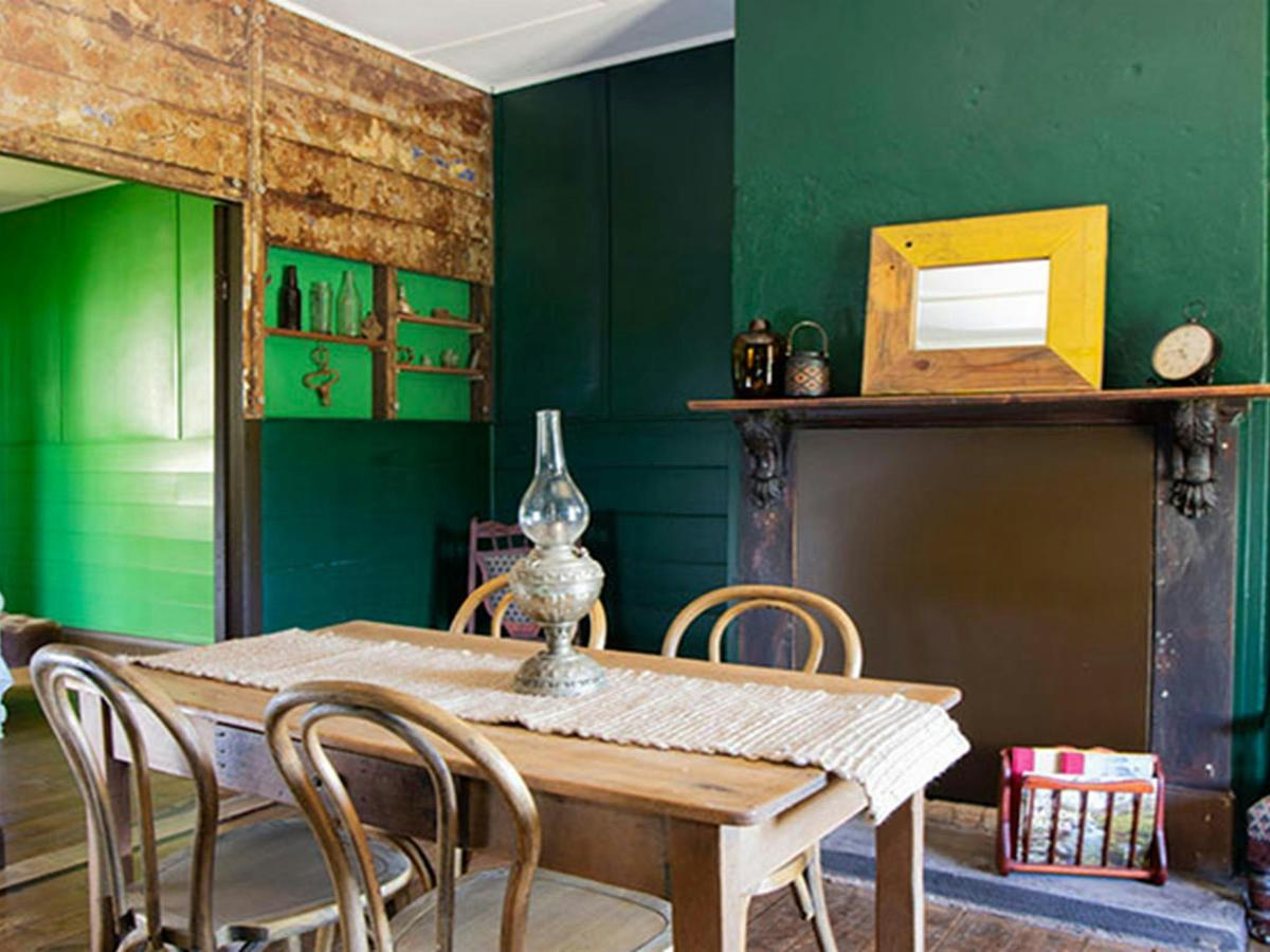 The dining room with dining table and 4 chairs at Sydney Hotel Cottage in Hill End Historic Site.