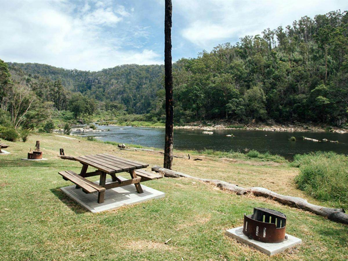 Picnic tables and fire pit by Nymboida River at The Junction campground, Nymboi-Banderay National