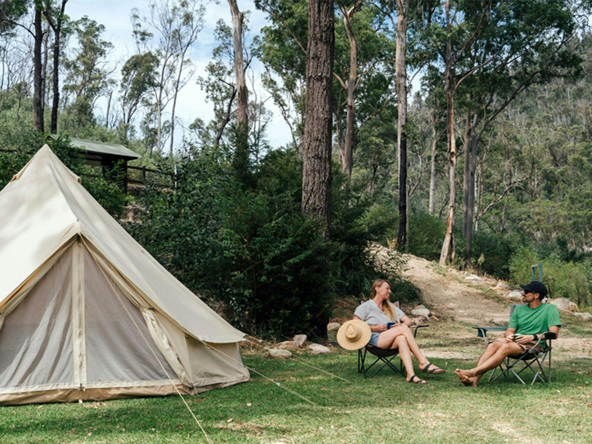 People sitting by their tent at The Junction campground, Nymboi-Binderay National Park. Photo: Jay