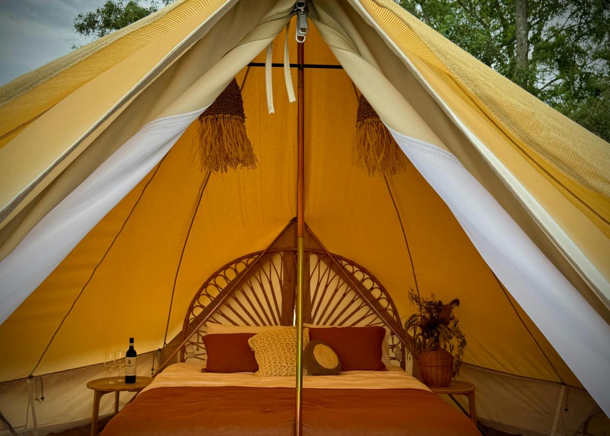 Full size king size bed in glamping tent.