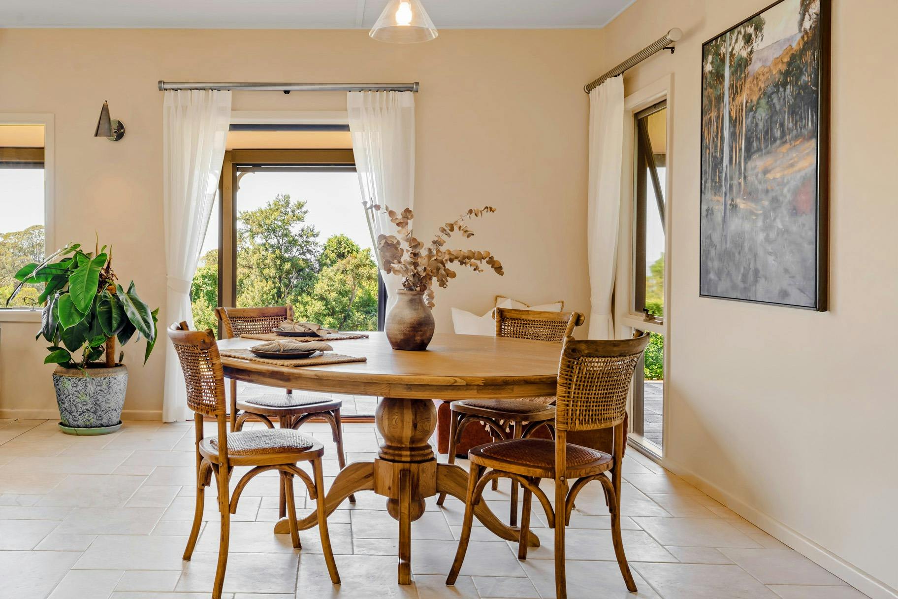 Country charm meets elegance—French doors, artwork, and a warm, inviting dining space