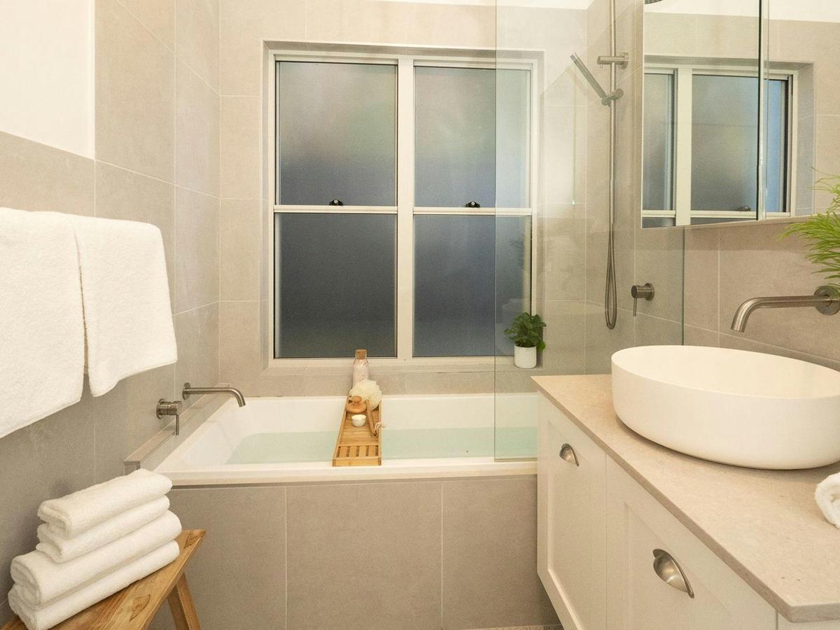 Sunshine Cottage | Bathroom | Bath | Shower | Vanity | Toilet | Bodywash | Shampoo | Conditioner