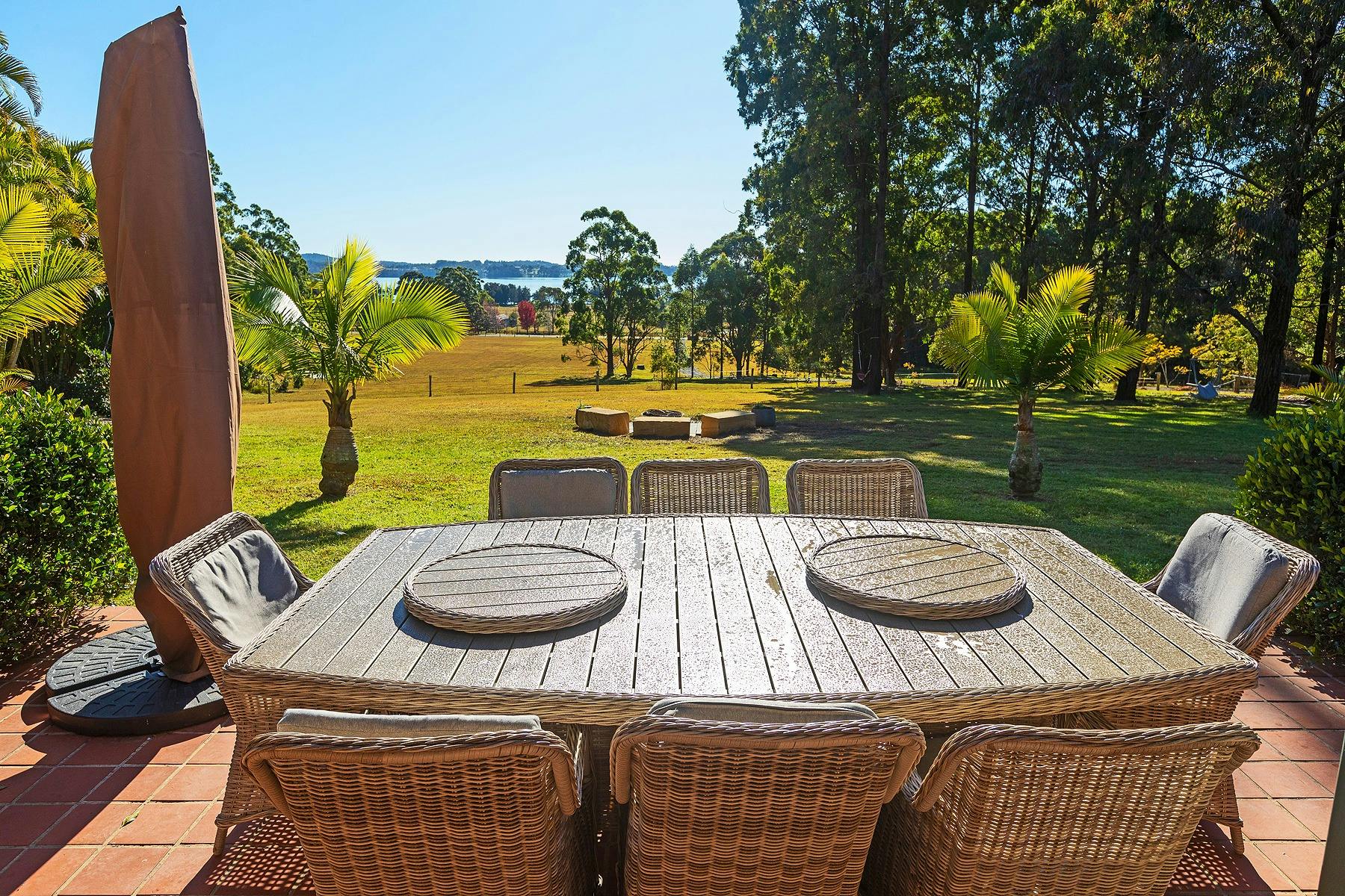 Outdoor dining with paddock and lake views