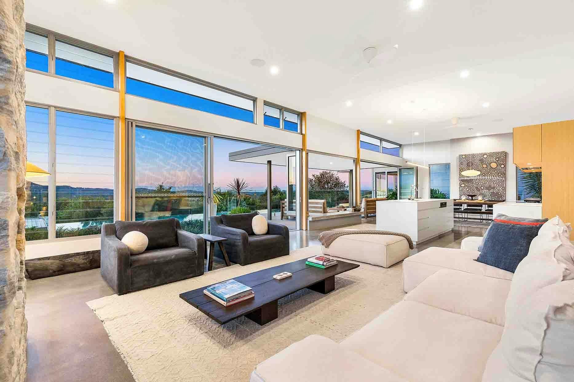The Springs - Byron Bay - Open-Plan Living, Kitchen and Dining area Flow to Outdoor Area at Dusk