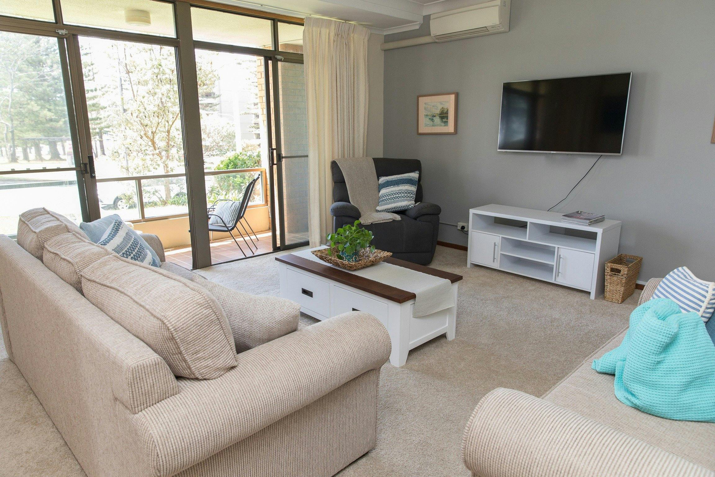 Taranaki Beach House | Opposite Town Beach - Lounge Room opens up to front porch