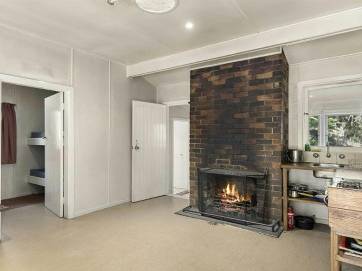 The interior of Toms Cabin with fireplace in New England National Park. Photo:  Mitchell Franzi
