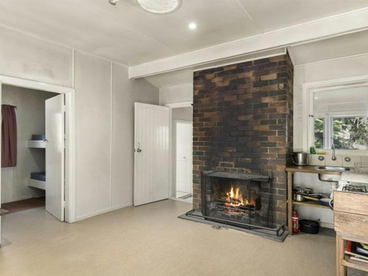The interior of Toms Cabin with fireplace in New England National Park. Photo:  Mitchell Franzi