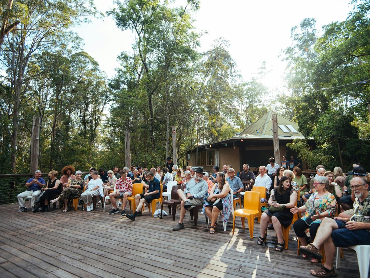 Group sitting on the deck at Wangat Lodge, for outdoor theater, Hunter Valley