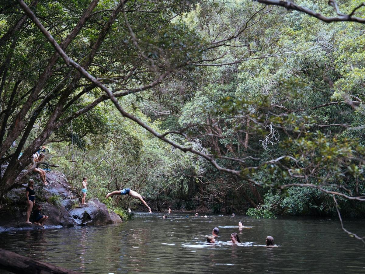 People swimming at deep waterhole in Chichester River on the property of Wangat Lodge Hunter Valley