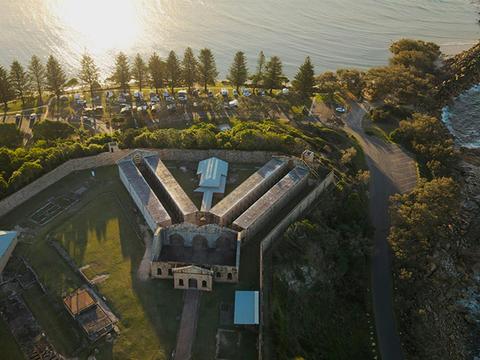 Aerial view of Trial Bay Gaol and the waterfront campsites. Credit: Glen Ellis &copy; DCCEEW