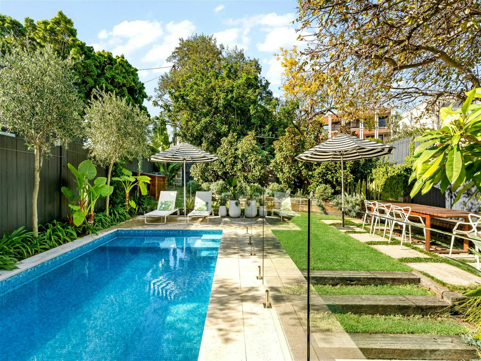 Set among a lush green garden and adjacent to the stunning pool