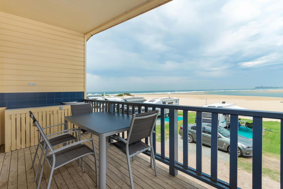 Elevated Beach View cabin - Balcony with outdoor dining setting & barbecue