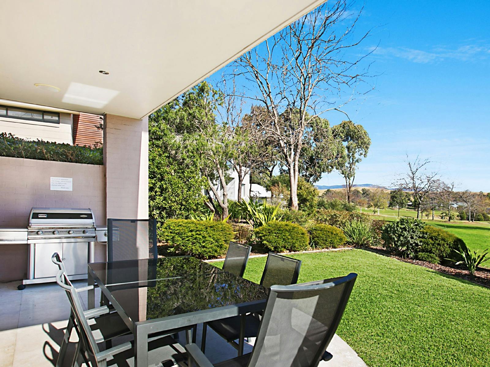 Villa Saachi outdoor entertainment area with BBQ with golf and parkland views