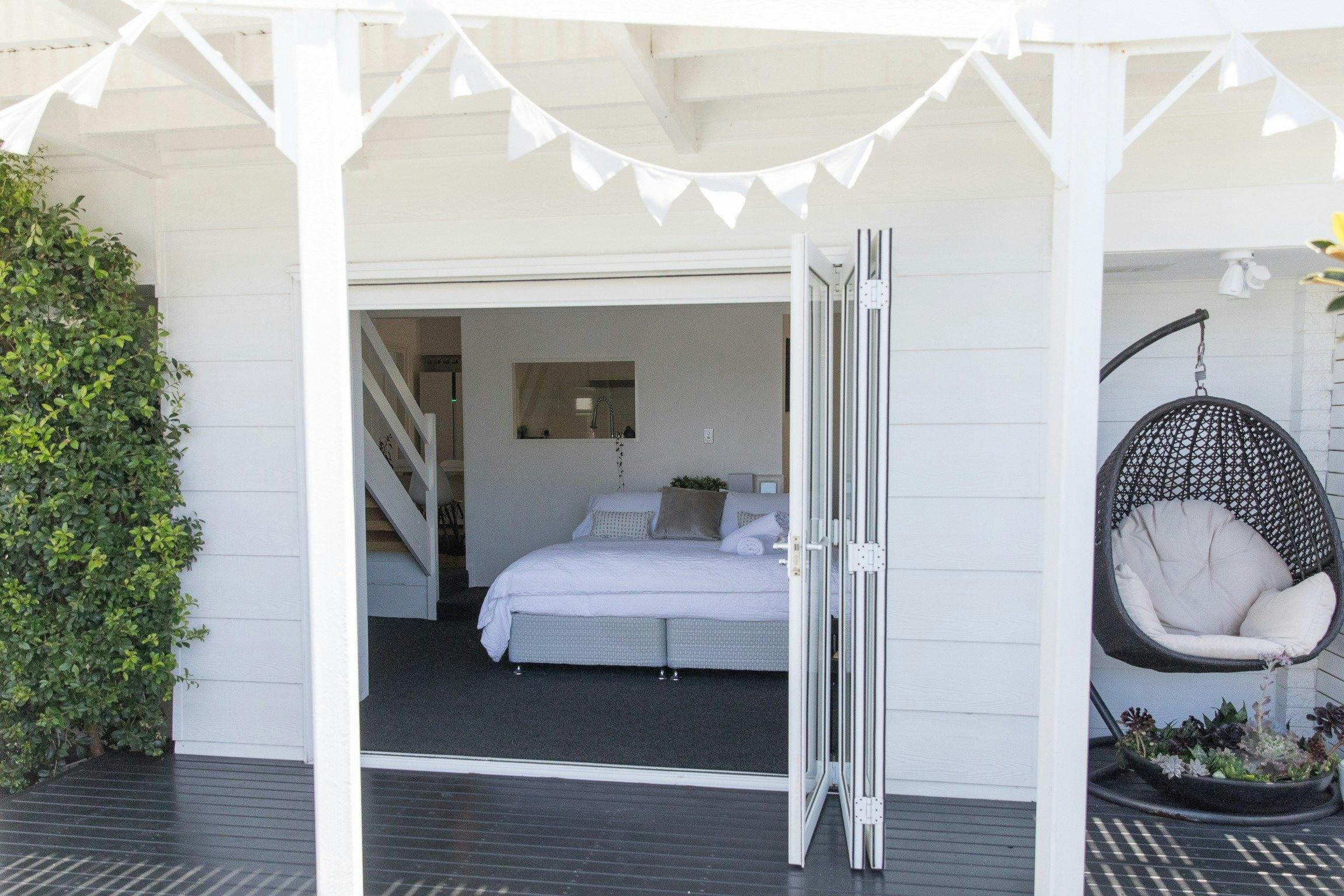 White Beach Cottage - Master bedroom opening out onto deck