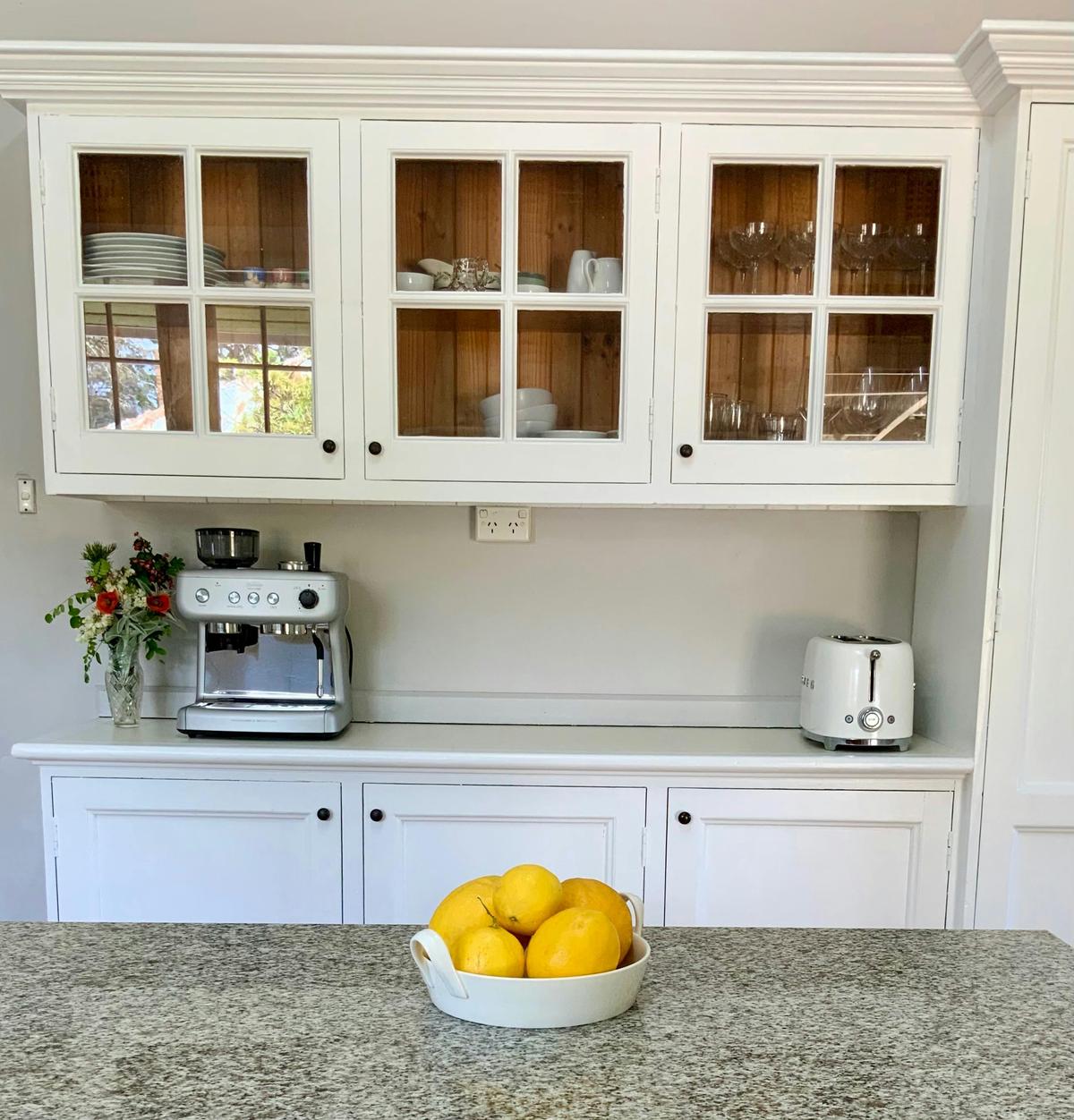 The country style kitchen features an espresso machine, Smeg toaster, Miele dishwasher & double oven