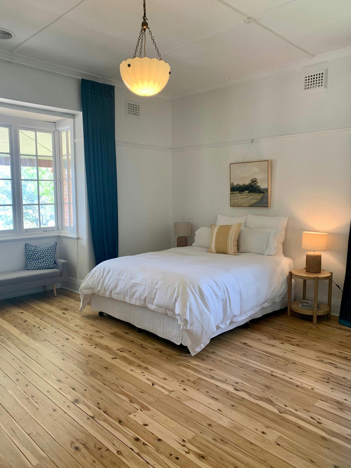 The master bedroom is roomy and has an ornamental open fire place