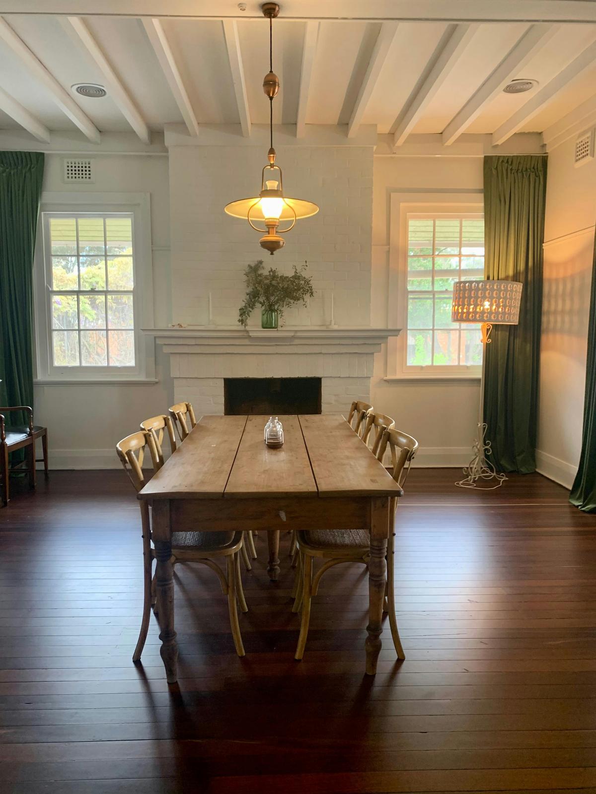 The dining room seats 8. The ceiling to floor velvet curtains give the room a feeling of luxury.