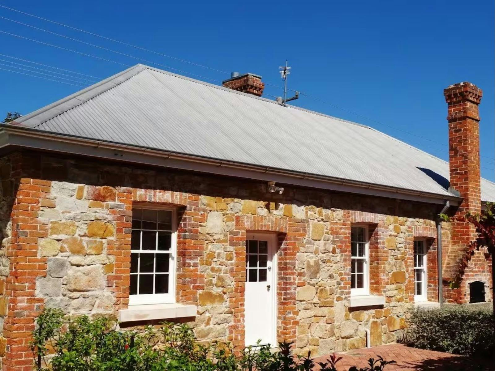 White Rose Cottage exterior featuring heritage-listed brickwork