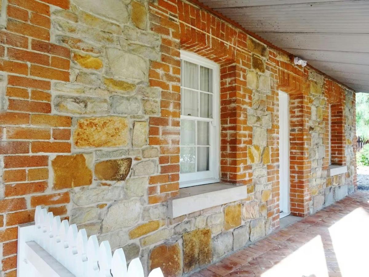 White Rose Cottage exterior featuring heritage-listed brickwork