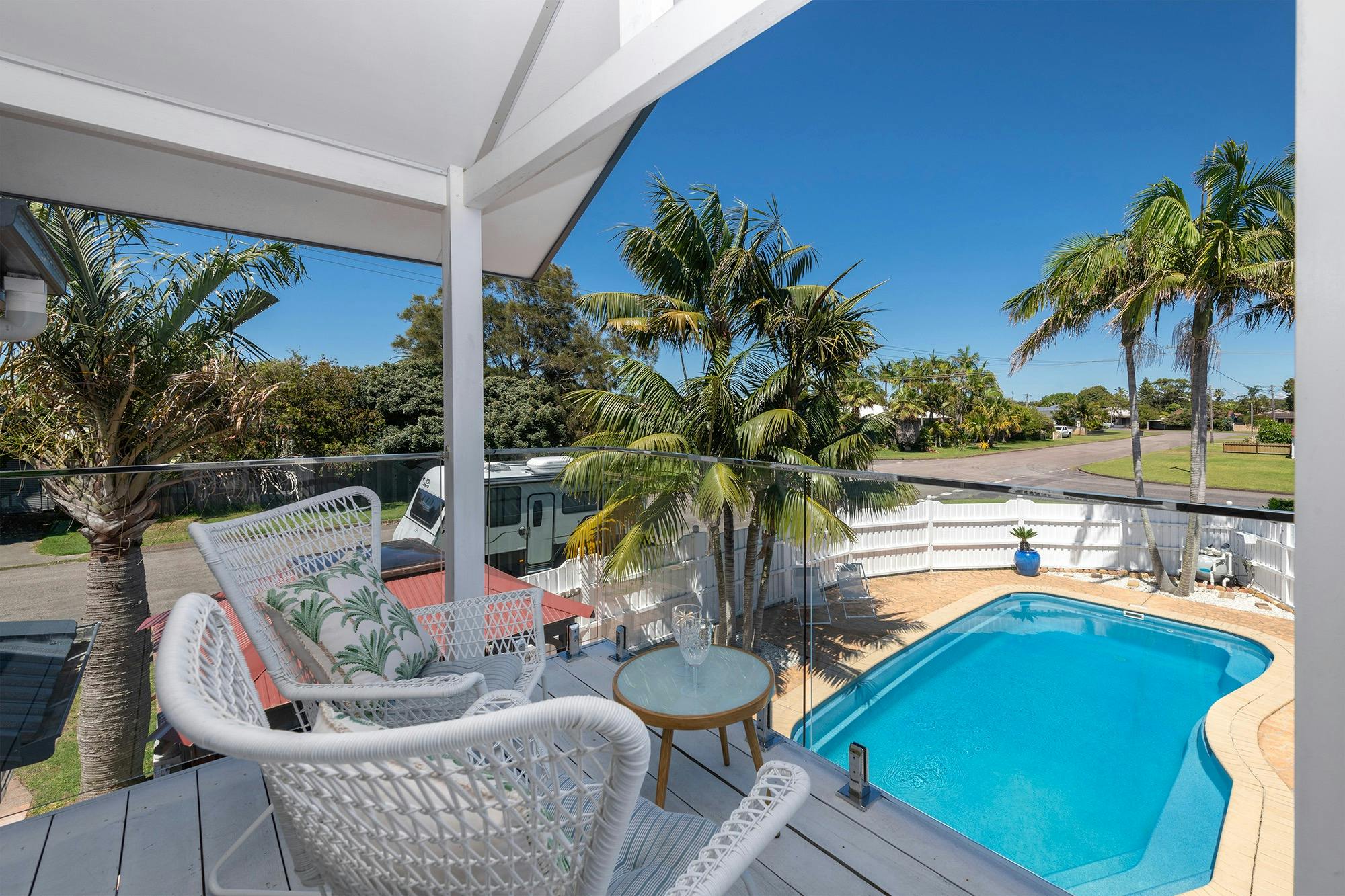 Private glass enclosed deck, perfect for pool watching and sunset viewing
