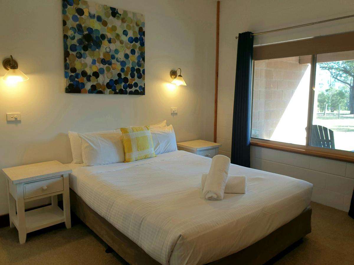 Bedroom with queen bed and wardrobe