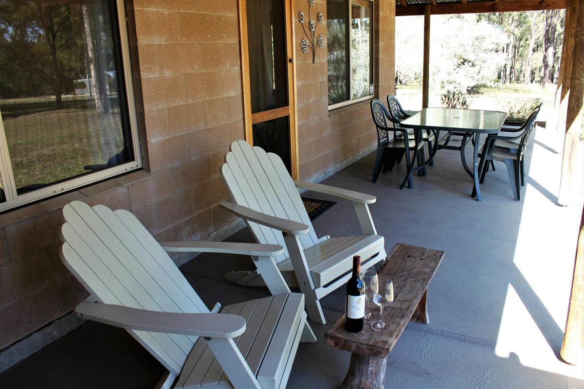 Private verandah with a gas BBQ, outdoor dining and recliner chairs