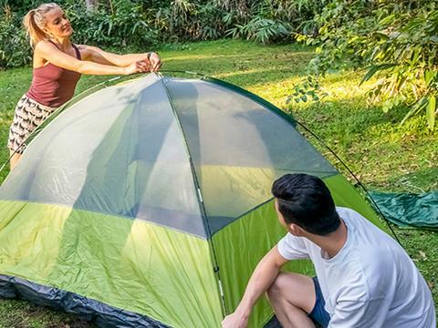 2 campers setting up a tent on the grass. Photo: John Spencer/DPIE