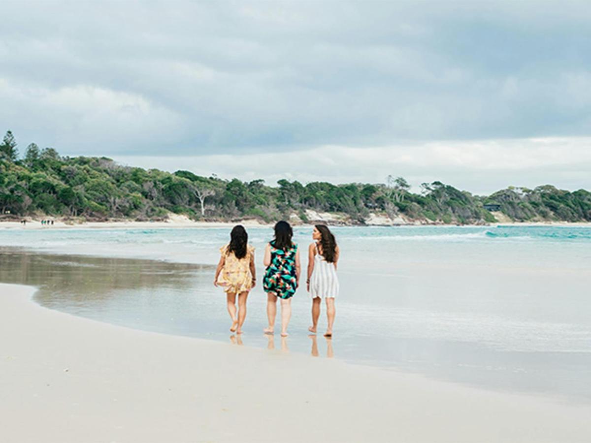 3 friends walking on The Pass beach in Walgun Cape Byron State Conservation Area. Photo: Sera