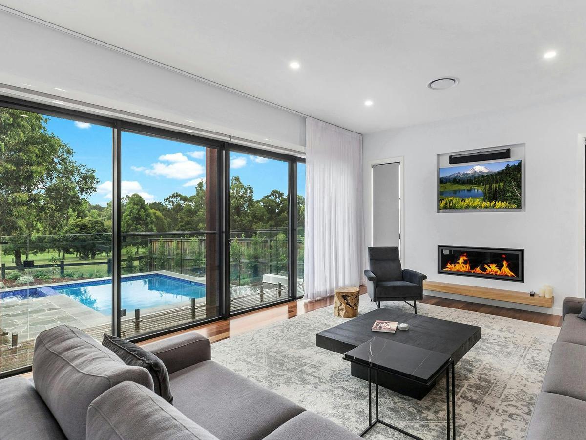 Villa Tallawanta lounge room with fireplace and pool area