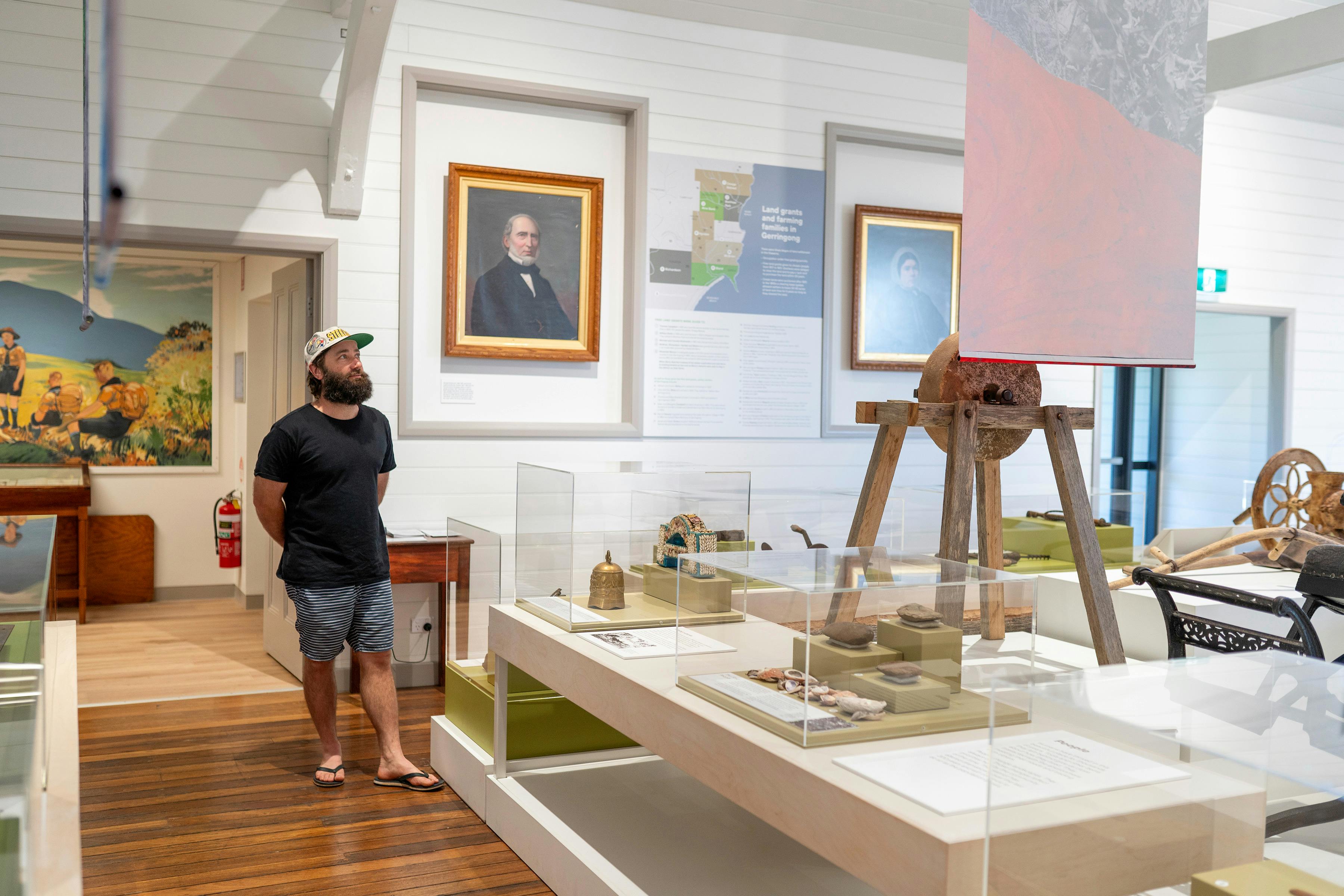 A man looking at historical objects.