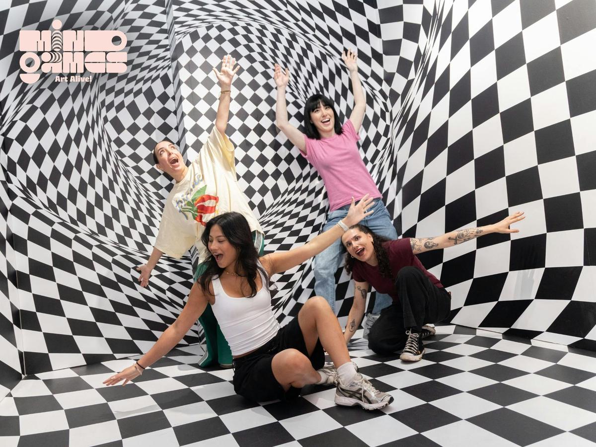 Visitors experience the Wonky Wall illusion at Mind Games | Art Alive in Sydney.