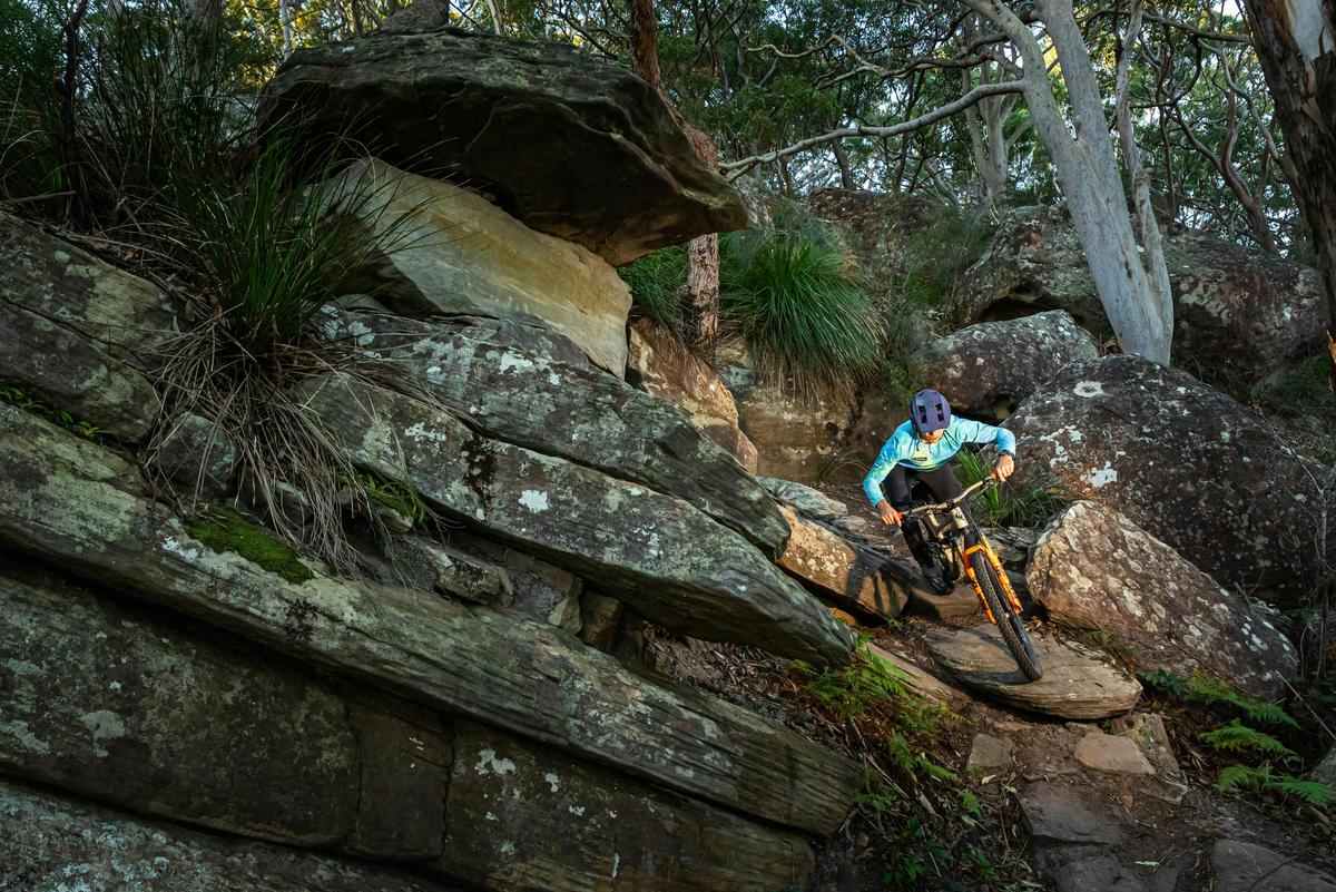Expert mountain biker on steep technical trail
