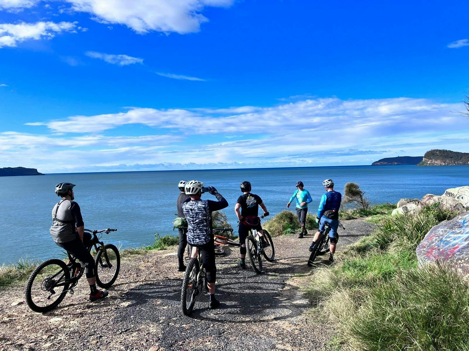 Group of mountain bikers on dramatic coastal track