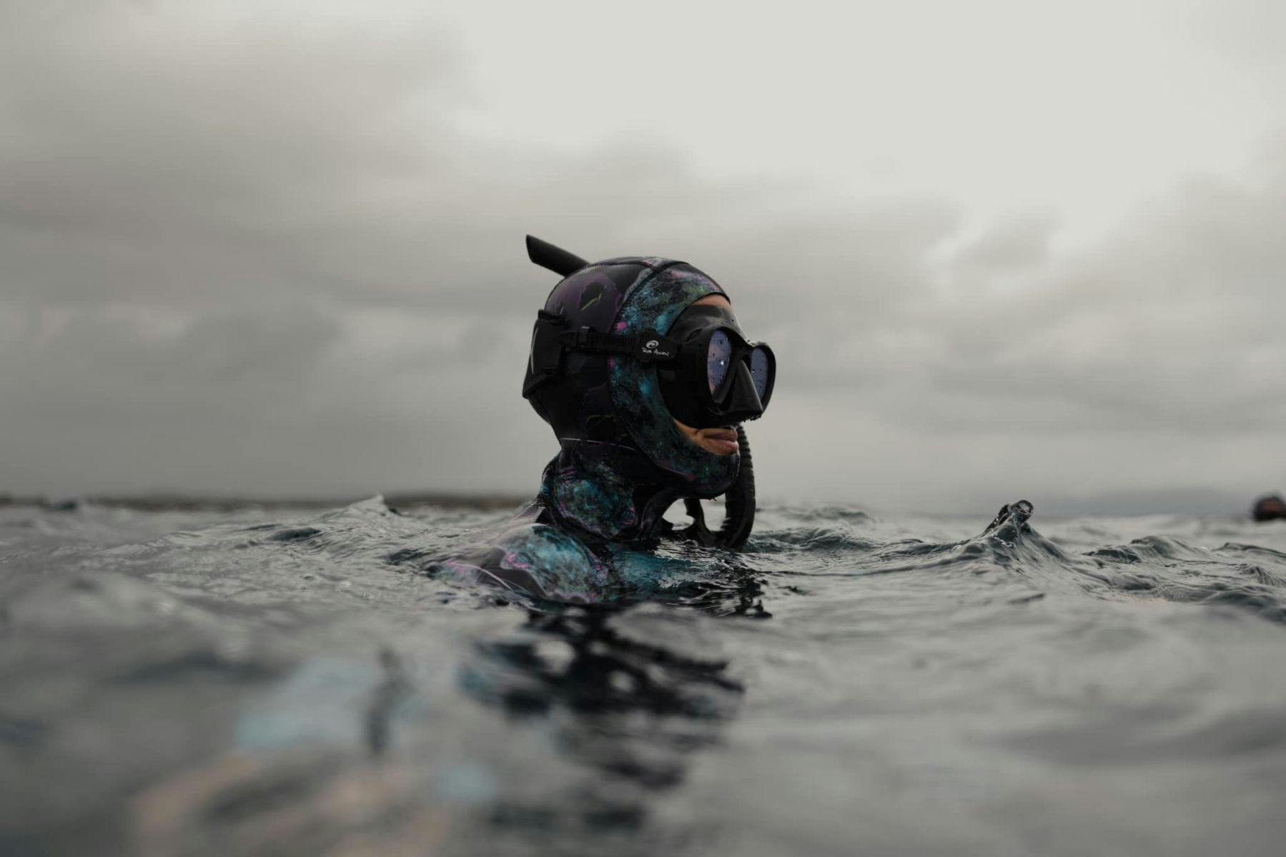 Freediver in the water with their head above the water