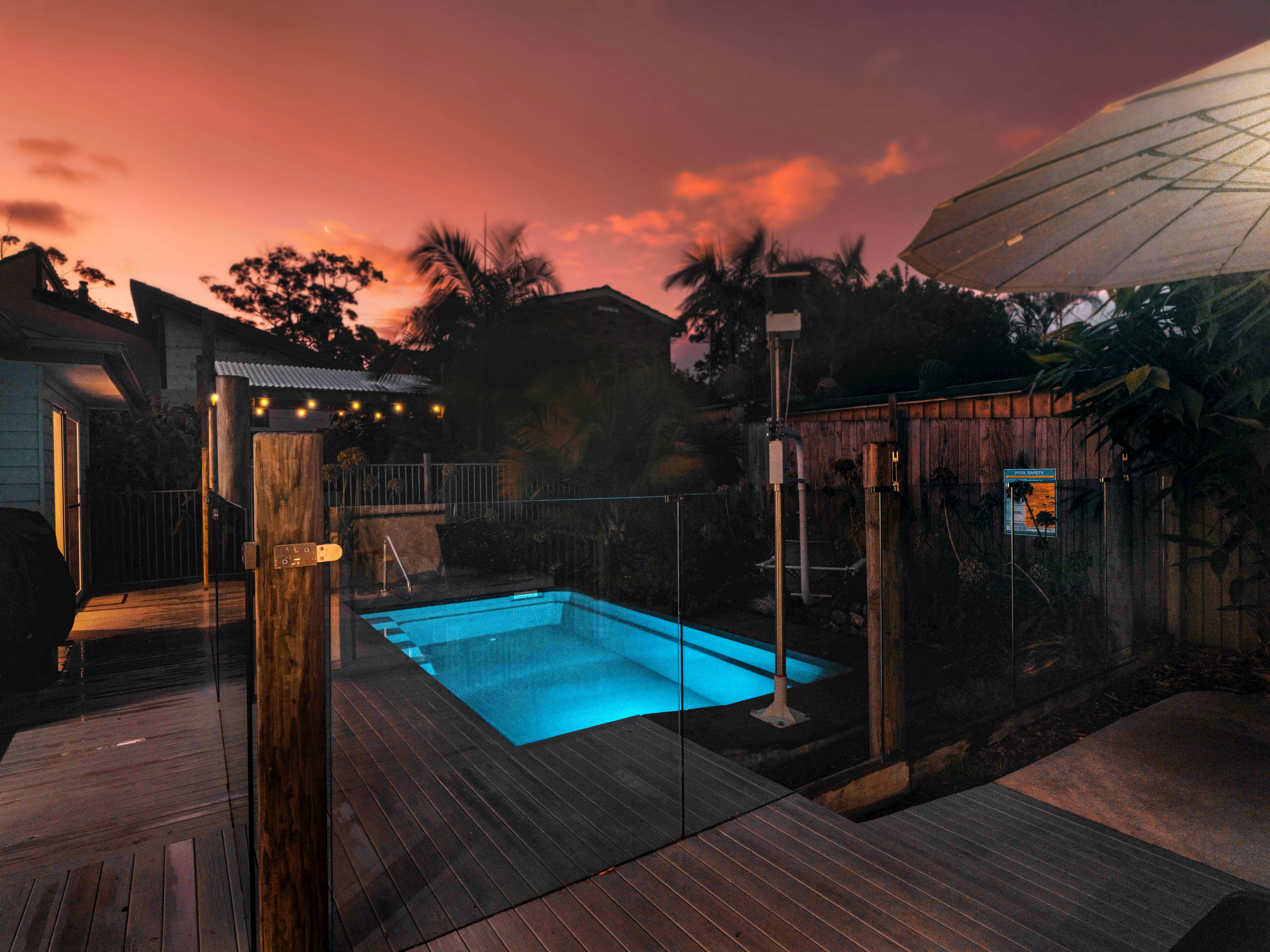Accessible pool with hoist & backyard of wheelchair accessible accommSeafarers Diamond Beach at dusk