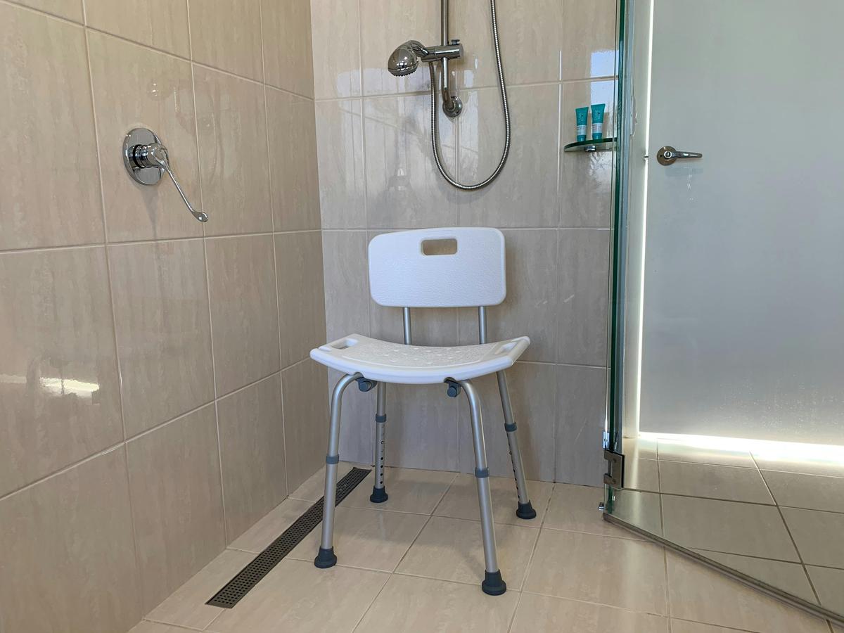 Shower chair in open wide shower