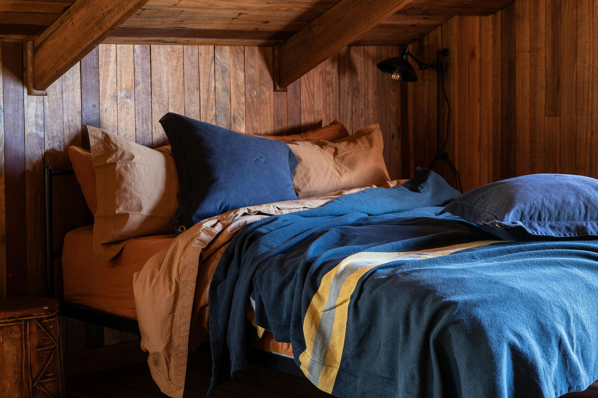A comfy queen bed with Pony Rider organic canvas duvet, eco-friendly feather pillows.