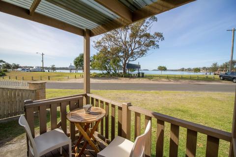 Deck of Studio Cabin with outdoor seating and electric BBQ